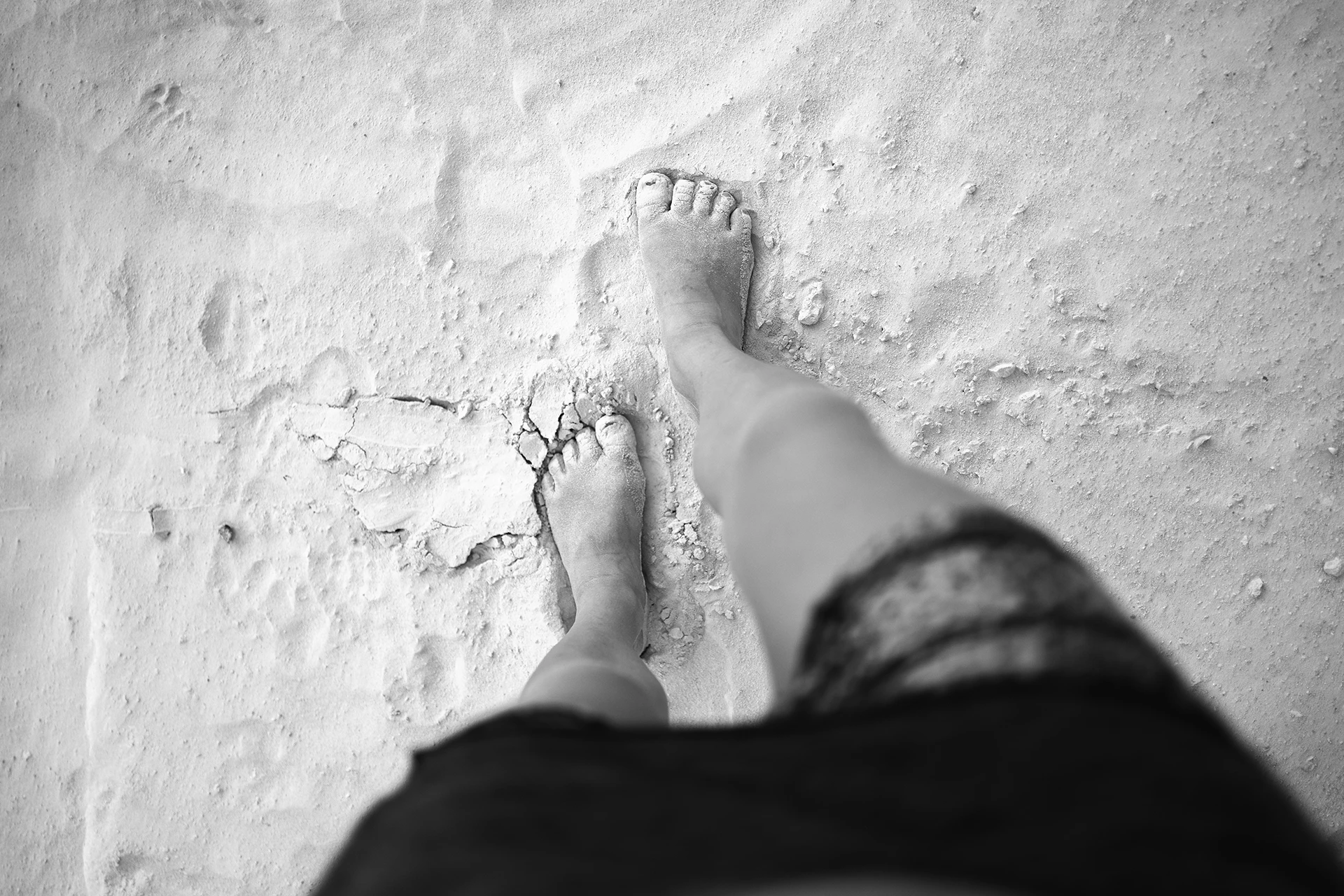 feet in the sand walking